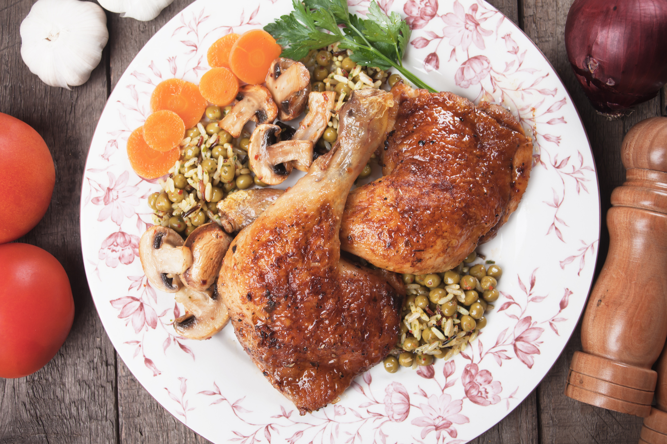 Roasted chicken legs with rice and green peas, classic of traditional cuisine